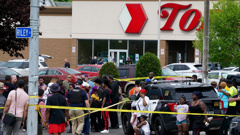 People gather outside a supermarket in Buffalo, New York, where 10 people were killed on May 14. (Photo / AP)