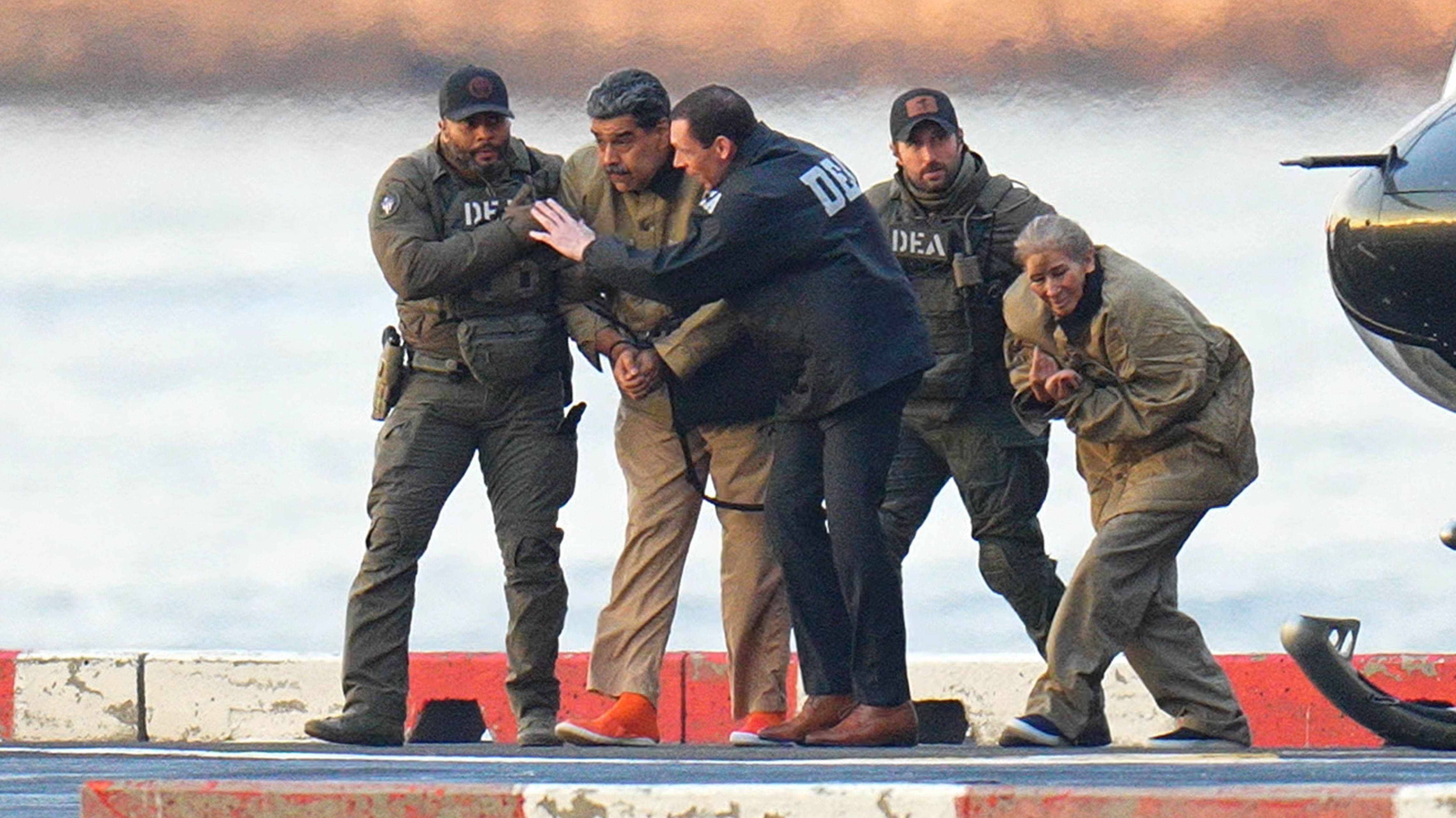 Nicolas Maduro and his wife, Cilia Flores, are seen in handcuffs after landing at a Manhattan helipad, escorted by heavily armed Federal agents as they make their way into an armored car en route to a Federal courthouse in Manhattan on January 5, 2026 in New York City. (Photo by XNY/Star Max/GC Images)