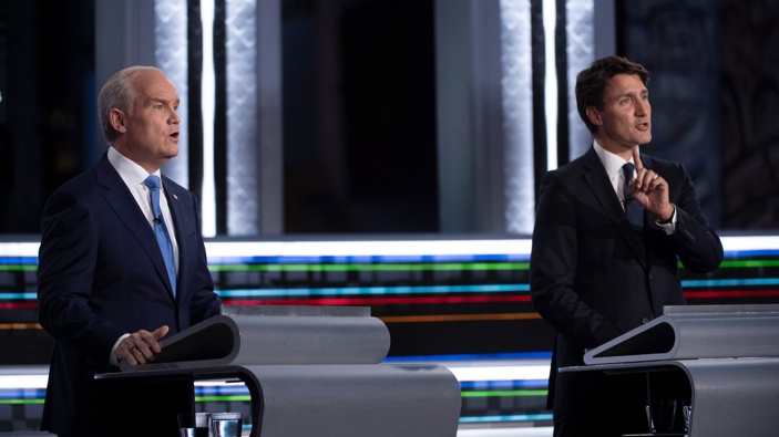 Conservative leader Erin O'Toole, left, and Liberal leader Justin Trudeau speak during the federal election French-language leaders debate in Gatineau, Quebec. (Photo / AP)