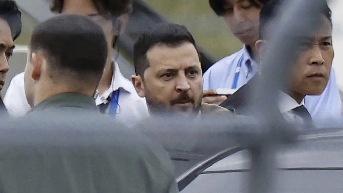 Ukrainian President Volodymyr Zelenskyy walks to a car upon his arrival at Hiroshima Airport today. Photo / AP