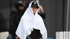 Jess Kerr shelters from the rain during the White Ferns v Australia T20 cricket match at Eden Park in April 2021 - are we set for a repeat weather spoiler for the men's T20 international tomorrow? Photo / Photosport