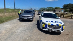 Police turned around traffic after motorists burst through a gate. Photo / David Fisher 