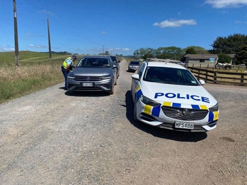 Police turned around traffic after motorists burst through a gate. Photo / David Fisher