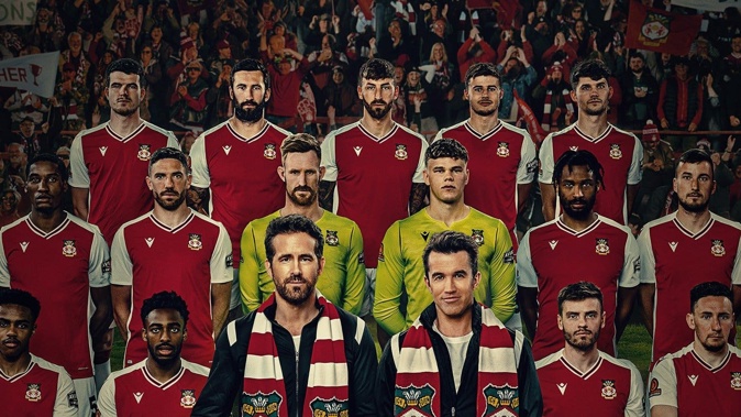 Ryan Reynolds and Rob McElhenney with the Wrexham team in the documentary Welcome to Wrexham.