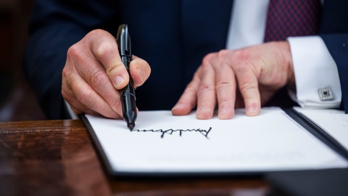 US President Donald Trump signs executive orders in the Oval Office of the White House in Washington, DC, US, on Monday, Jan. 20, 2025. Photographer: Jim Lo Scalzo/EPA/Bloomberg via Getty Images