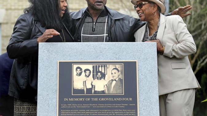 Relatives of the Groveland Four, from left, Vivian Shepherd, niece of Sam Shepherd, Gerald Threat, nephew of Walter Irvin; Carol Greenlee, daughter of Charles Greenlee, gather at the just-unveiled monument. (Photo / AP)