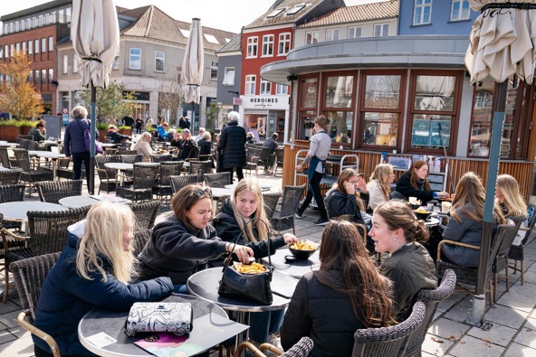 People sit outside a restaurant for outdoor service in Roskilde Denmark, as cafes and bars reopened, after 548 days with restrictions. (Photo / AP)