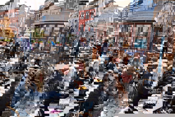 People sit outside a restaurant for outdoor service in Roskilde Denmark, as cafes and bars reopened, after 548 days with restrictions. (Photo / AP)