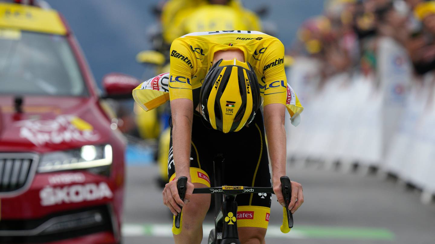 Slovenia's Tadej Pogacar reacts as he crosses the finish line with a delay to lose his overall leader's yellow jersey. Photo / AP