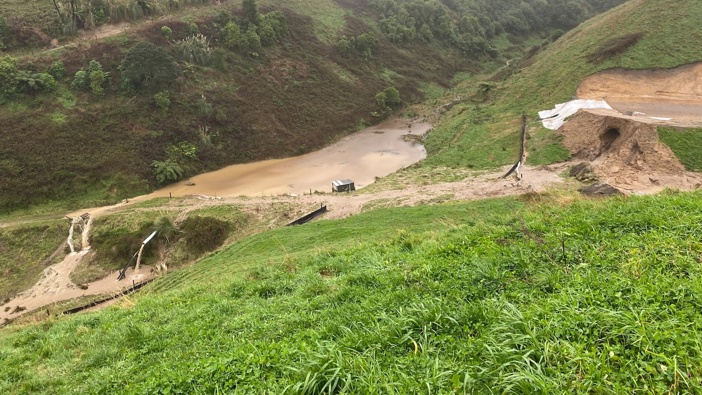Sediment-laden water discharging from a hole in a sediment retention pond and flowing over land at a kiwifruit development property in in 2022. Photo / Bay of Plenty Regional Council