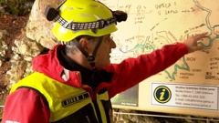 In this photo, taken from a video, a rescuer inspects the map of Krizna Jama cave near Grahovo, Slovenia, Sunday Jan 7, 2024. Photo / AP
