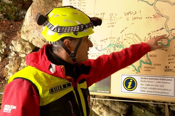 In this photo, taken from a video, a rescuer inspects the map of Krizna Jama cave near Grahovo, Slovenia, Sunday Jan 7, 2024. Photo / AP