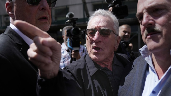 Robert De Niro, center, argues with a Donald Trump supporter after speaking to reporters in support of President Joe Biden across the street from Trump's criminal trial in New York, Tuesday, May 28, 2024. (AP Photo/Seth Wenig)