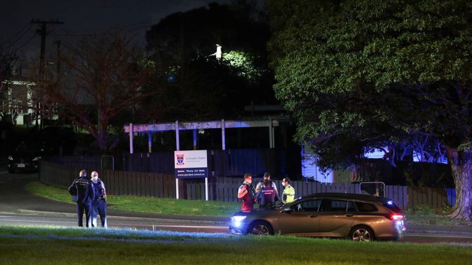 Police officers at the scene of a two-car crash in Auckland which claimed the life of one person. (Photo / Hayden Woodward)