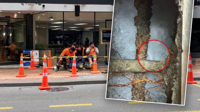 Construction workers attending to a sinkhole beneath the footpath on Manners St in central Wellington. Photo / Vita Molyneux