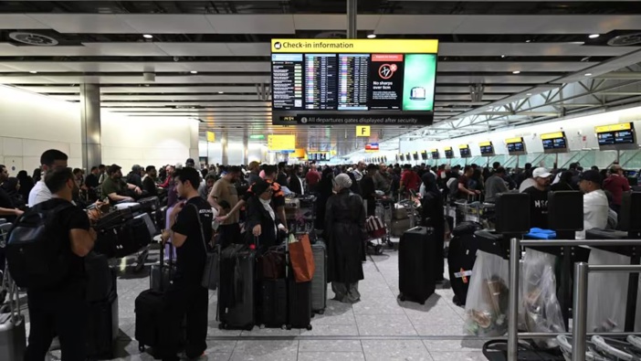 Travellers wait in terminal 4 at Heathrow Airport, west of London, after major European airports were hit by "cyber-related disruption". Photo / Justin Tallis, AFP