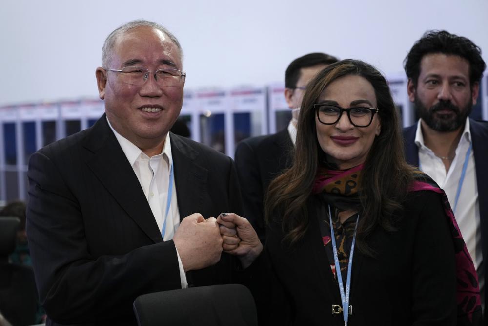 Xie Zhenhua, China's special envoy for climate, left, and Sherry Rehman, minister of climate change for Pakistan, pose for photos during a break in a closing plenary session at the COP27 U.N. Climate Summit, Sunday, Nov. 20, 2022, in Sharm el-Sheikh, Egypt. (AP Photo/Peter Dejong)
