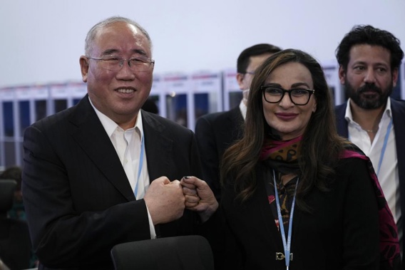 Xie Zhenhua, China's special envoy for climate, left, and Sherry Rehman, minister of climate change for Pakistan, pose for photos during a break in a closing plenary session at the COP27 U.N. Climate Summit, Sunday, Nov. 20, 2022, in Sharm el-Sheikh, Egypt. (AP Photo/Peter Dejong)