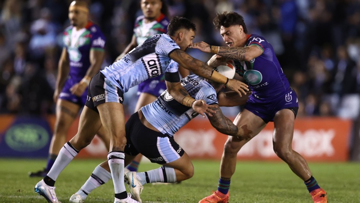 Charnze Nicoll-Klokstad of the Warriors is tackled by Briton Nikora of the Sharks during the round 14 NRL match between Cronulla Sharks and New Zealand Warriors at Sharks Stadium on June 07, 2025 in Sydney, Australia. (Photo by Jason McCawley/Getty Images)