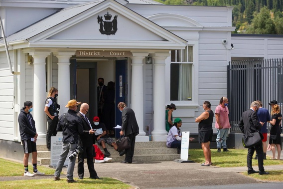 People wait outside Te Kuiti District Court for Tom Philips to appear at his first court hearing. (Photo / Mike Scott)