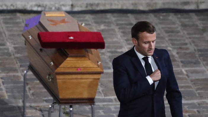 French President Emmanuel Macron leaves after paying his respects by the coffin of slain teacher Samuel Paty in the courtyard of the Sorbonne university during a national memorial event, Wednesday, Oct. 21, 2020 in Paris. Photo / AP