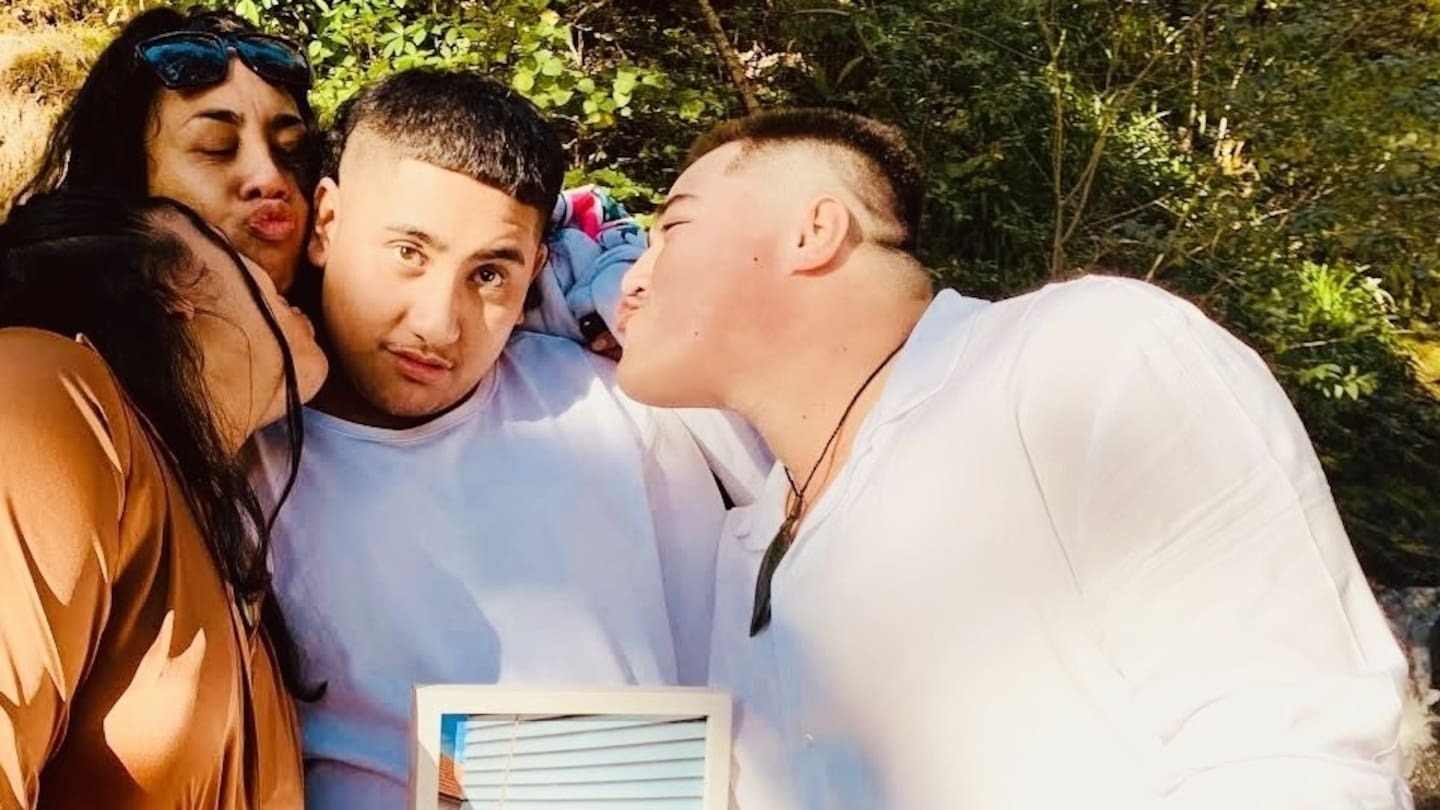 Pictured left to right in June 2023: Siblings Sapphire Patuwai, Afyna Patuwai, Raphael Patuwai and Sapphire's husband Hoani Atkins-Williams Patuwai. Raphael is holding a photo of his father Robert Patuwai who died when Raphael was 12.