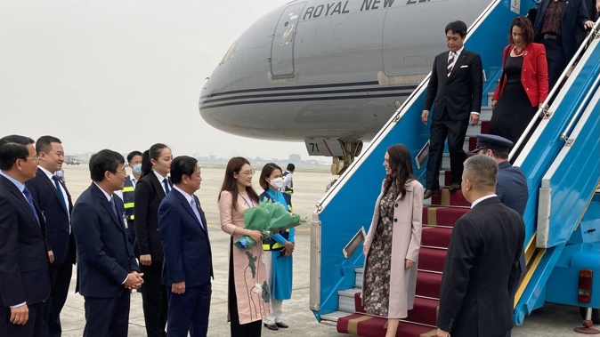 Prime Minister Jacinda Ardern arriving in Hanoi to be met by Viet Nam's Minister for Agriculture Lê Minh Hoan (centre) at the beginning of her three-day trip in Vietnam. Photo / Pool