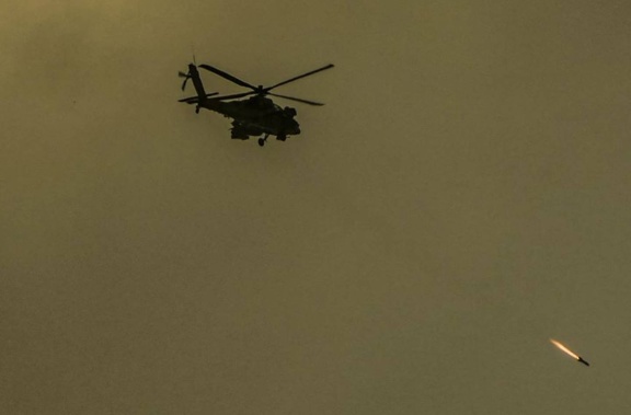 An Israeli Apache helicopter fires a missile in the direction of the Gaza Strip, as seen from southern Israel. Photo / AP