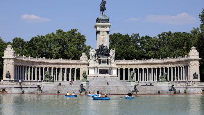 People sail on a lake in a park during the first heatwave of the summer in Madrid, on June 28. Photo / AFP