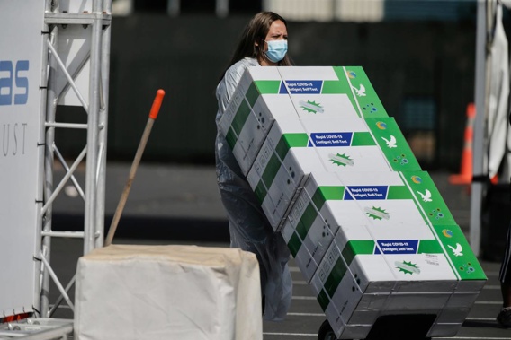 Rapid antigen tests are brought in to be handed out at a testing station in the Auckland suburb of Ōtara. (Photo / Alex Burton)