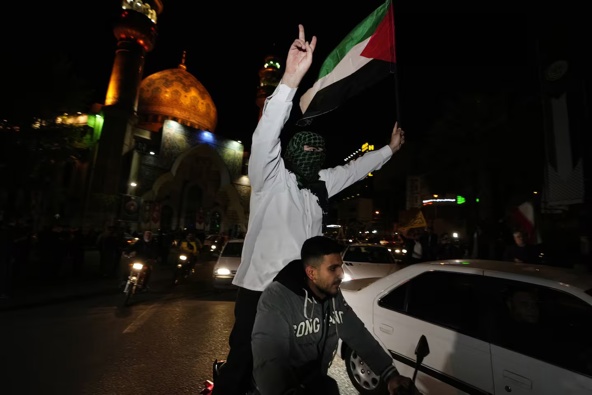 Iranian demonstrators wave a Palestinian flag during their anti-Israeli gathering in Tehran, Iran, earlier today. Photo / AP