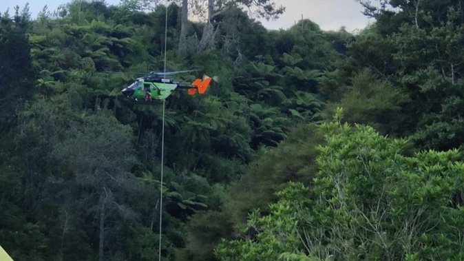 A helicopter at the scene of the Wairoa River near Poripori Rd, Lower Kaimai, after a person died in a water-related incident.