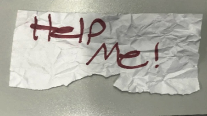A "Help Me!" sign used by a 13-year-old girl kidnapped in Texas. Photo / AP
