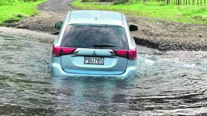 Ivan Benseman’s Mitsubishi Outlander had to be written off after this fording of a stream on the Motu Rd in September. Photos / Supplied