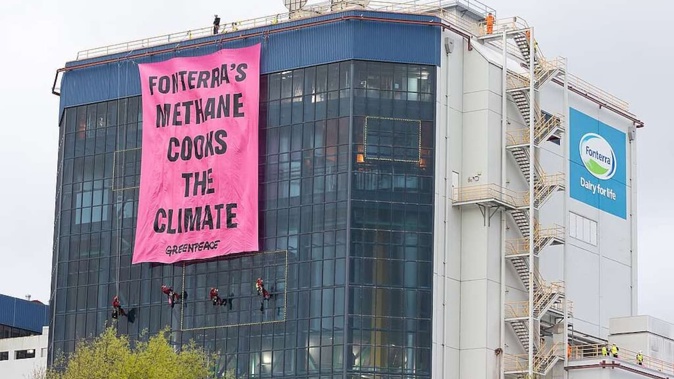 Greenpeace activists have scaled Fonterra’s Te Rapa Dairy Factory, unfurling a 160sq m banner.