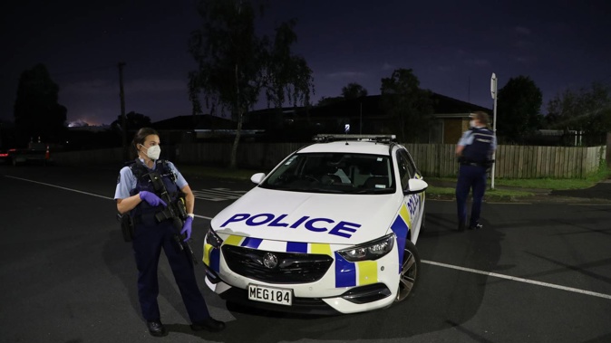 Armed police in Henderson, West Auckland, early this morning. (Photo / Hayden Woodward)