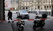 Police vehicles are seen as police officers stand guard outside the Louvre Museum as people are evacuated after it received a written threat, in Paris, Saturday Oct. 14, 2023. Photo / AP