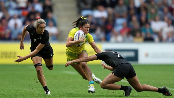 Charlotte Caslick of Team Australia is tackled by Tyla Nathan-Wong and Sarah Hirini of Team New Zealand during the Women's Rugby Sevens Semi-Final. Photo / Getty Images