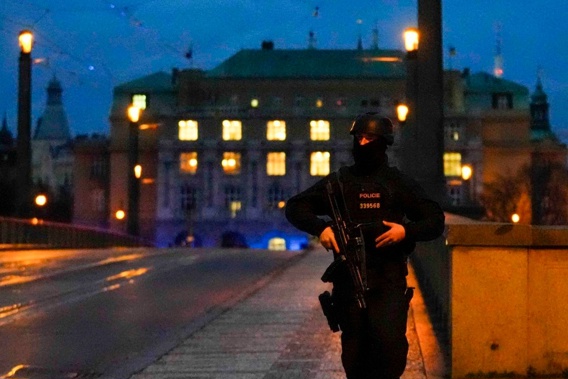 A police officer on a bridge over the Vltava river in downtown Prague following a shooting in downtown Prague which has left at least 15 people dead. Photo / AP