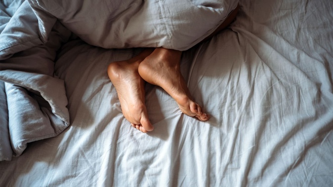 A sleeping woman was filmed in an explicit way by a man who then used the video to threaten her. Photo / NZME