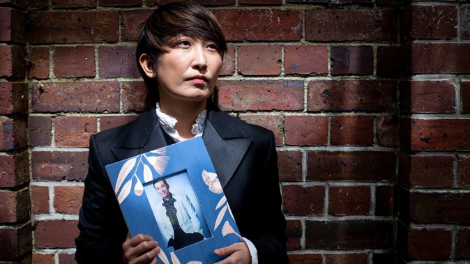 Nan Jiang holds a picture of her ex-husband Wei Chen. Photo / Dean Purcell