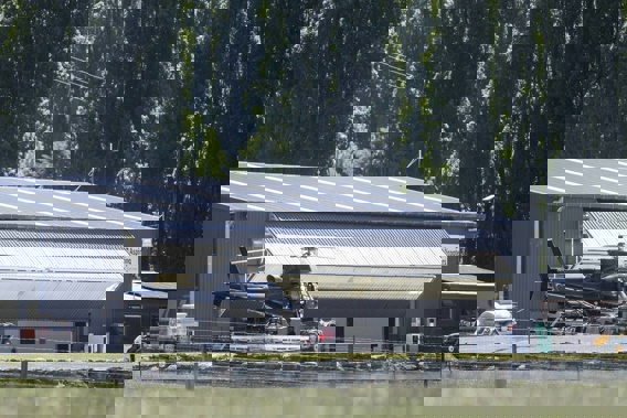 A black unmarked helicopter linked to the filming at Aspiring Helicopters hangar. Photo / George Heard