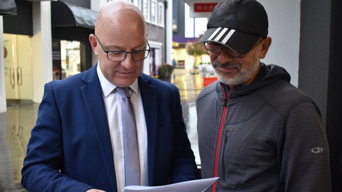 Waimakariri MP Matt Doocey and ICU nurse Carlos Molina look over medical exemption documents during a meeting in Rangiora. (Photo / Adam Burns)