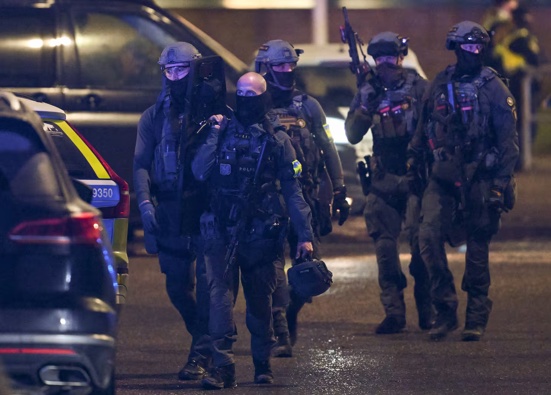 Police special forces are seen leaving the scene of the Risbergska School in Örebro, Sweden, following reports of a school shooting. Photo / AFP