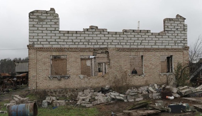 Vadym, 59, is seen in a window of his destroyed house in the village of Moshun, outside Kyiv, Ukraine. Photo / AP