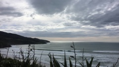 One person has died and another is still missing after being swept off the rocks at Papanui Point in Raglan.