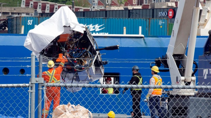 Debris from the Titan submersible is unloaded from the ship Horizon Arctic at the Canadian Coast Guard pier in St. John's, Newfoundland. Photo / Paul Daly, The Canadian Press via AP