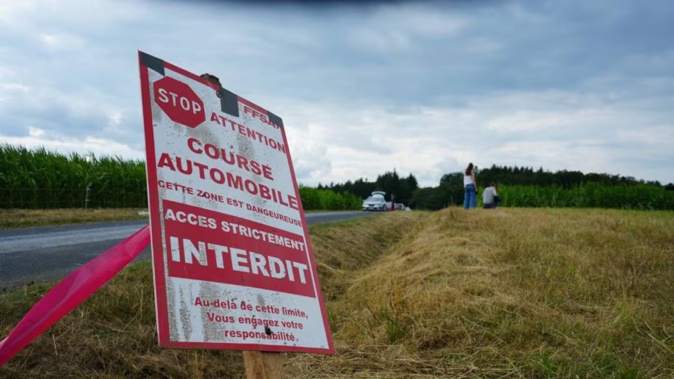 A sign prohibiting access near the scene where spectators were killed after being hit by a car that veered off the road during an auto rally in Saint-Just, France. Photo / Sylvain Thizy, AFP