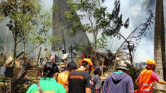 Rescuers search for bodies from the site where a Philippine military C-130 plane crashed in Patikul town, Sulu province, southern Philippines. Photo / AP